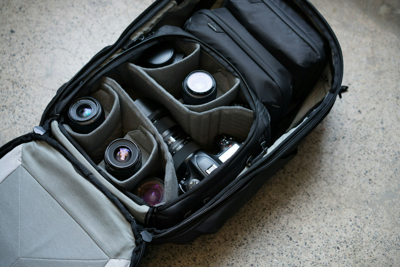 Peak Design Travel Backpack 45L Open With Camera Cube And Lenses Open Peak Design Travel Backpack 45L Showing A Camera Cube Packed With Lenses
